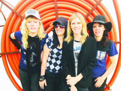 4 women posing in front of spiral background