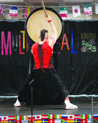 Man playing traditional drums at the Nashua Multicultural Festival