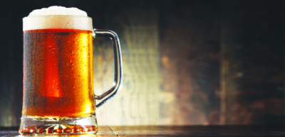 Composition with glass of beer on wooden background.