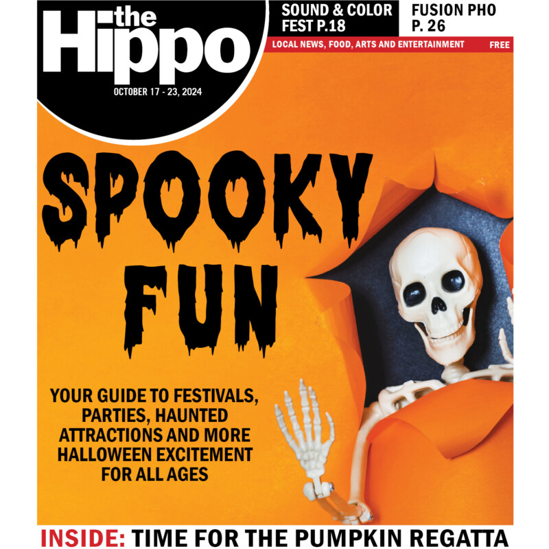 plastic skeleton popping out of torn orange paper, text in black drippy font saying spooky fun