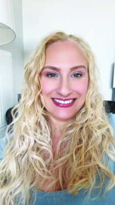 headshot of smiling woman with curly blonde hair