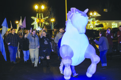 large blow-up kelpie at front of walking parade at night