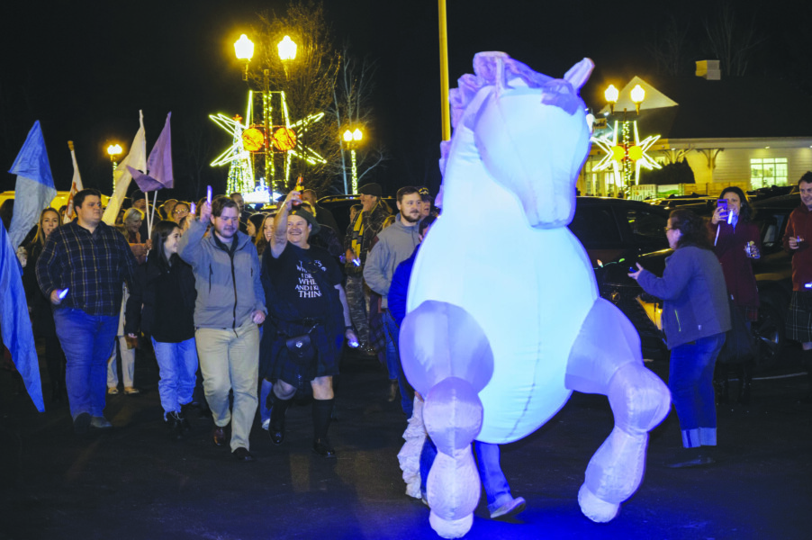 large blow-up kelpie at front of walking parade at night