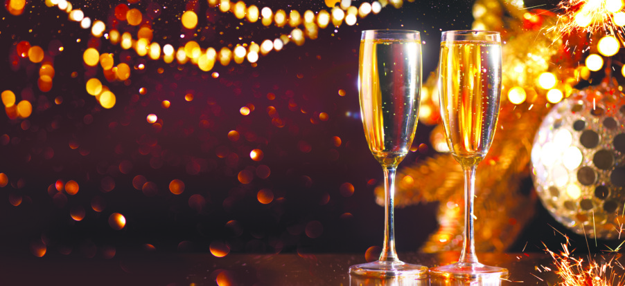 Holiday Champagne Flute over Golden glowing background.