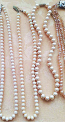 pearl necklaces laid out on flat surface