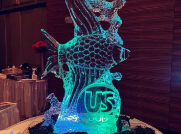 A glowing ice sculpture of an ornate fish