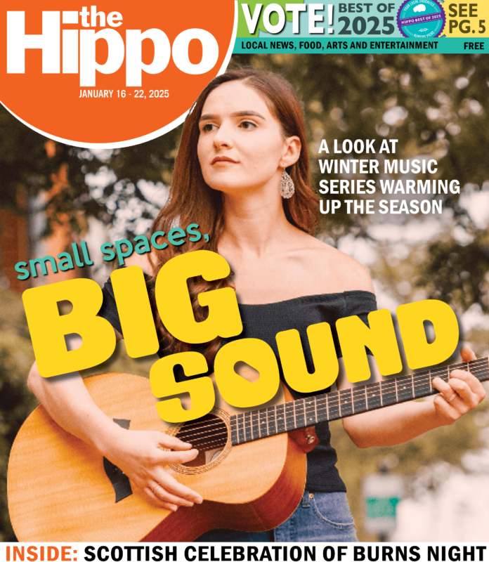 A Hippo cover showing a woman with a shoulderless T playing a guitar