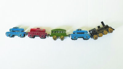 A small collection of little metal train car toys, multicolored