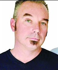 headshot of white man with short hair and small under lip beard