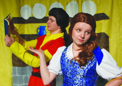 Two young actors play characters from Beauty and the Beast on stage