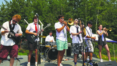 A young band wearing mismatched shorts and dress shirts with ties.