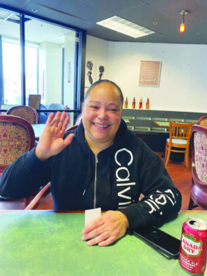 Kendra Smith waves and smiles as she has her photo taken.