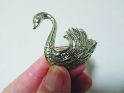 A metal pin of a swan. Courtesy photo.