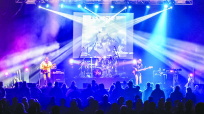 A live Lotus Land concert with fog and bright purple and blue lights