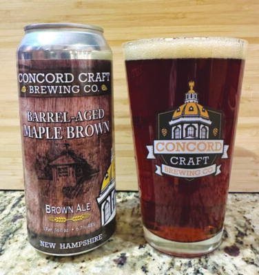 a beer can labelled Barrel-aged Maple Brown from Concord Craft Brewing Co. Sitting next to tall glass of medium dark beer with Concord Craft Brewing logo