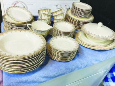 A large pile of ivory-colored antique plates and dishes.