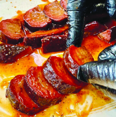 slices of sausage covered in glaze