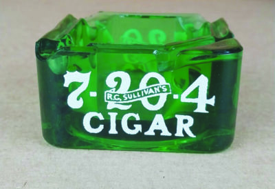 A green glass cigar box with a white graphic on the front.