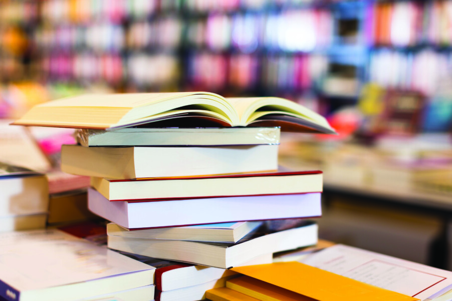 stack of art books lying on table in bookstore