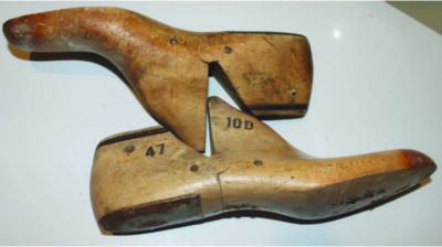 carved pieces of wood shaped like shoes lying on their sides
