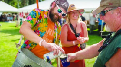 Two visitors to the Gate City Brewfest share a beer.