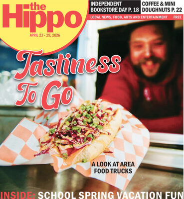 Front page of Hippo showing a man leaning out a food truck window holding out a loaded hot dog