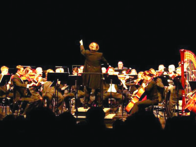 orchestra on dark stage, during performance