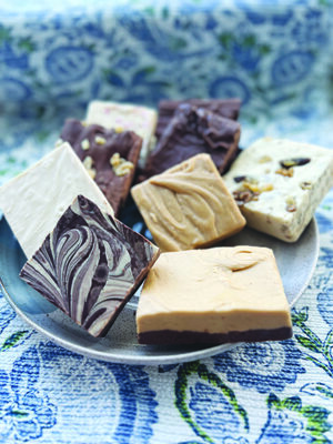 plate of different types of fudge cut into square pieces