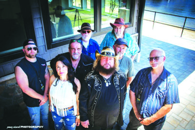 8 band members standing outside, looking up