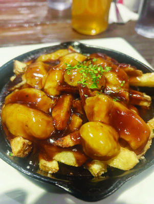 close up of small bowl of poutine