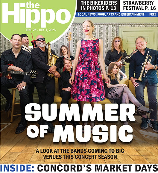 Frontpage of Hippo showing members of large band sitting and standing in old room, holding instruments, woman in the middle wearing colorful dress as focal point