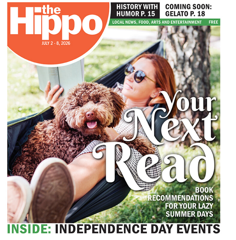 Frontpage of Hippo showing woman laying in hammock while reading book, a fluffy dog cuddled in her lap