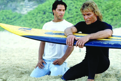 Keanu Reeves and Patrick Swayze in scene on beach from the movie Point Break