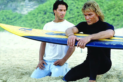 Keanu Reeves and Patrick Swayze in scene on beach from the movie Point Break