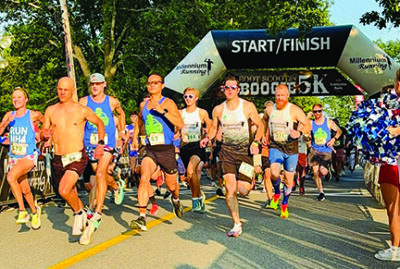 group of runners starting road race in early morning