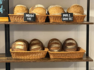 shelves with baskets each containing two loaves of bread