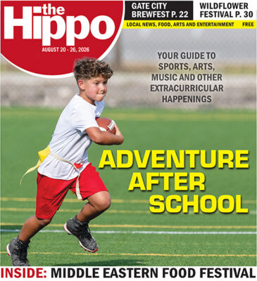Frontpage of Hippo showing young boy running on field during flag football team
