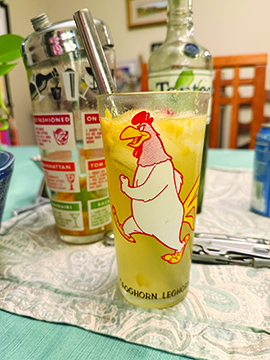 tall glass with cartoon chicken, filled with opaque drink