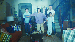 scene from The Last House, showing family in darkened living room, looking fearfully toward the window