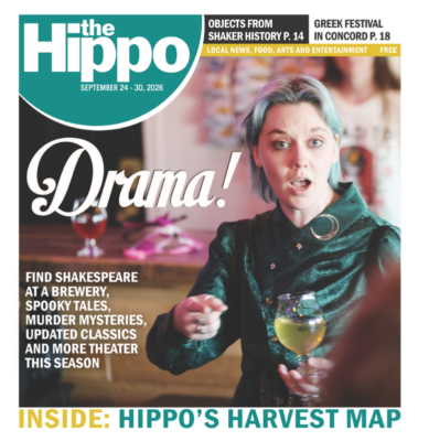 Frontpage of the HIPPO with the word Drama! in bold white letters and a woman holding a goblet with a pointed finger