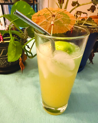 tall glass filled with opaque cocktail and ice