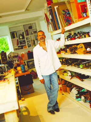 man standing in front of shelves in large studio