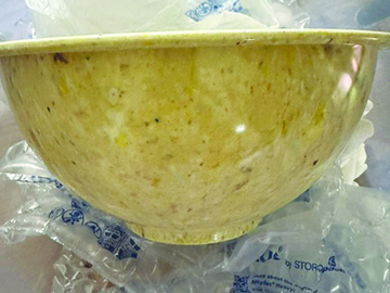 speckled tan serving bowl with foot and curved rim