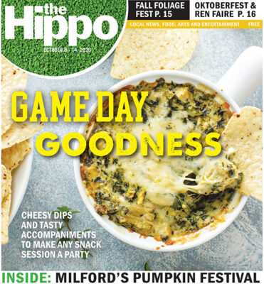 front page of the Hippo showing top view of bowl of cheesy spinach dip with corn chips