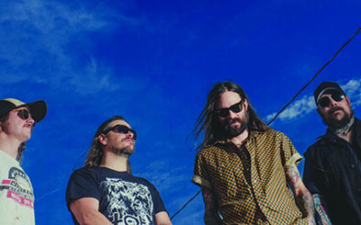 photo from low angle of four men with blue sky above