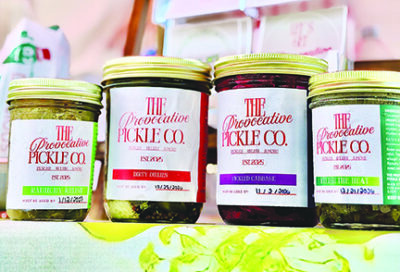 four jars of pickles on shelf