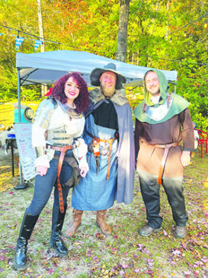 Three people dressed in fantasy renaissance outfits