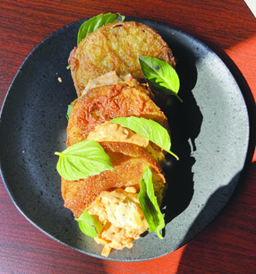 Fried green tomatoes artfully arranged on plate