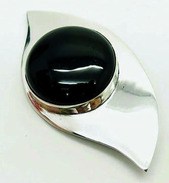 silver broach with large black stone in the middle